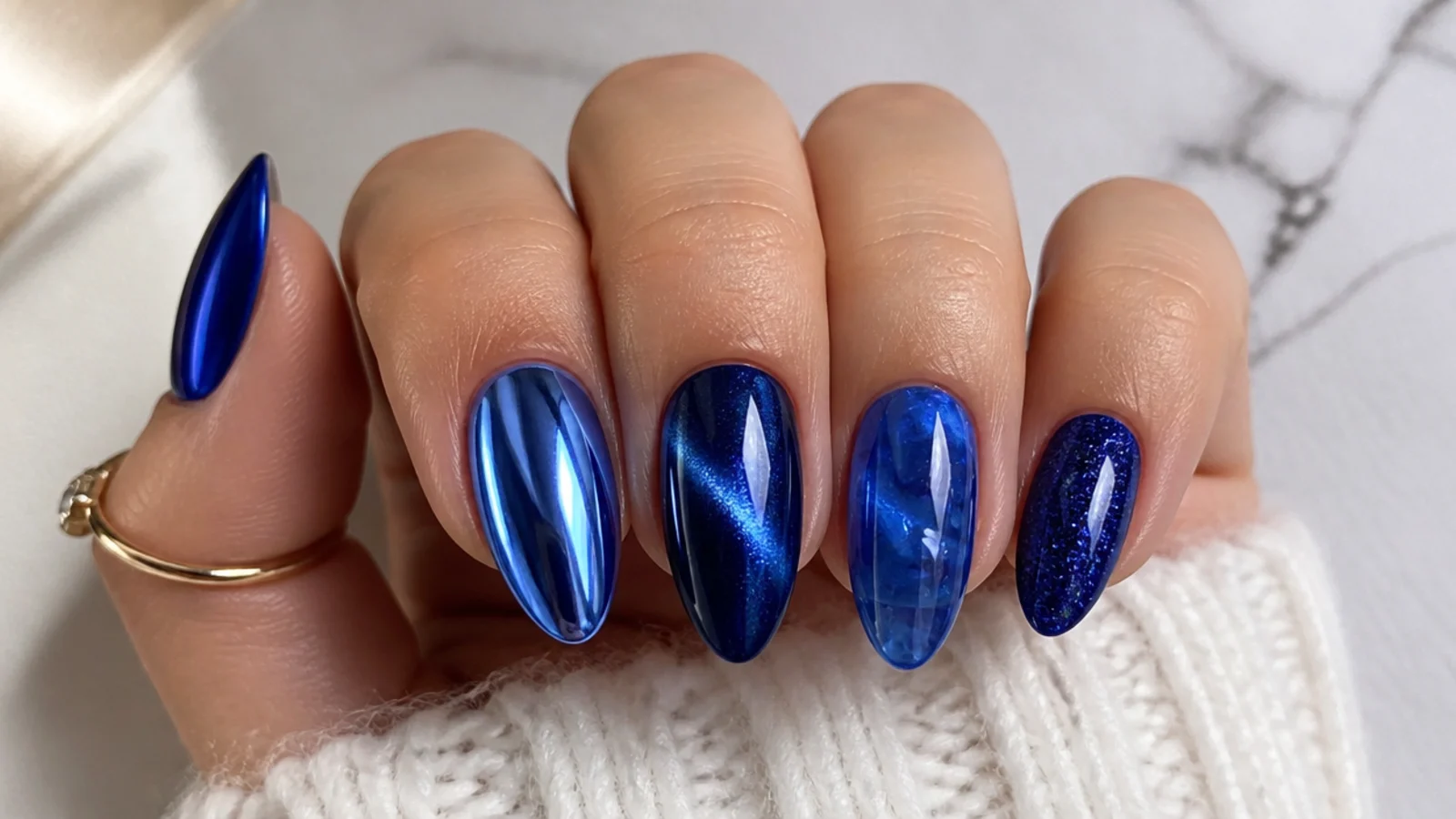 Royal blue nails in glossy, chrome, cat-eye and jelly finishes side by side