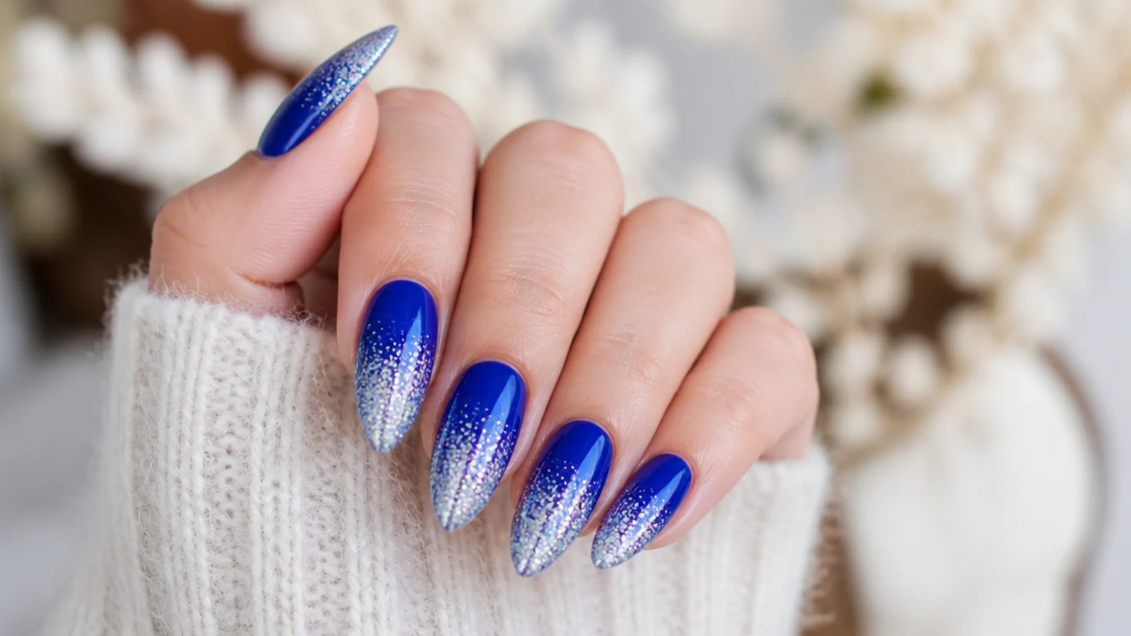 Royal blue nails fading into silver glitter at the tips