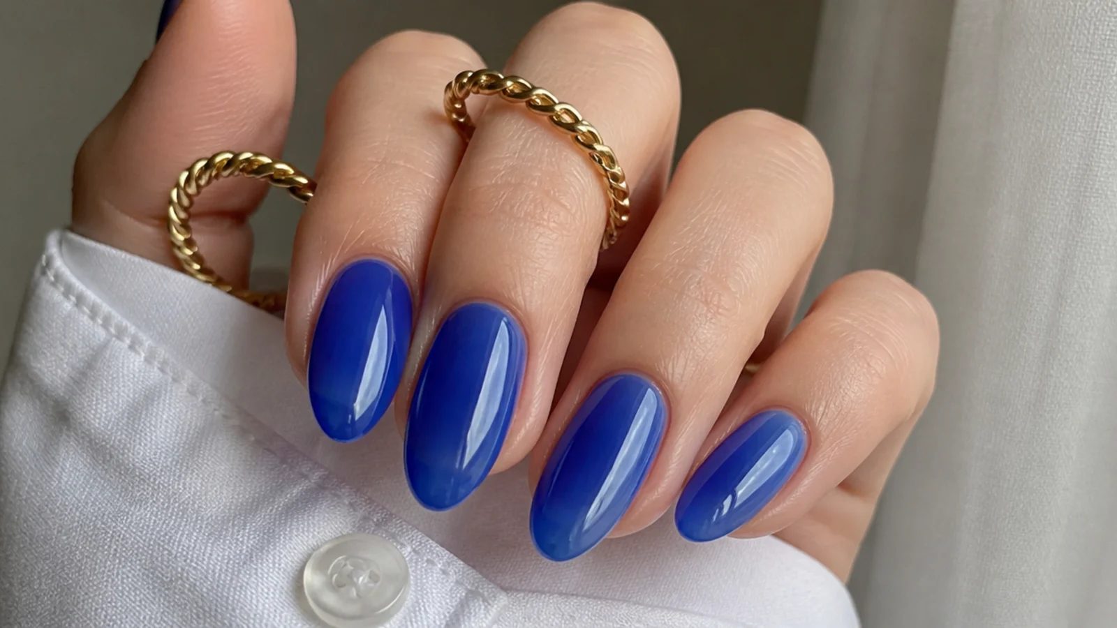 Sheer royal blue jelly nails with a high-gloss translucent finish