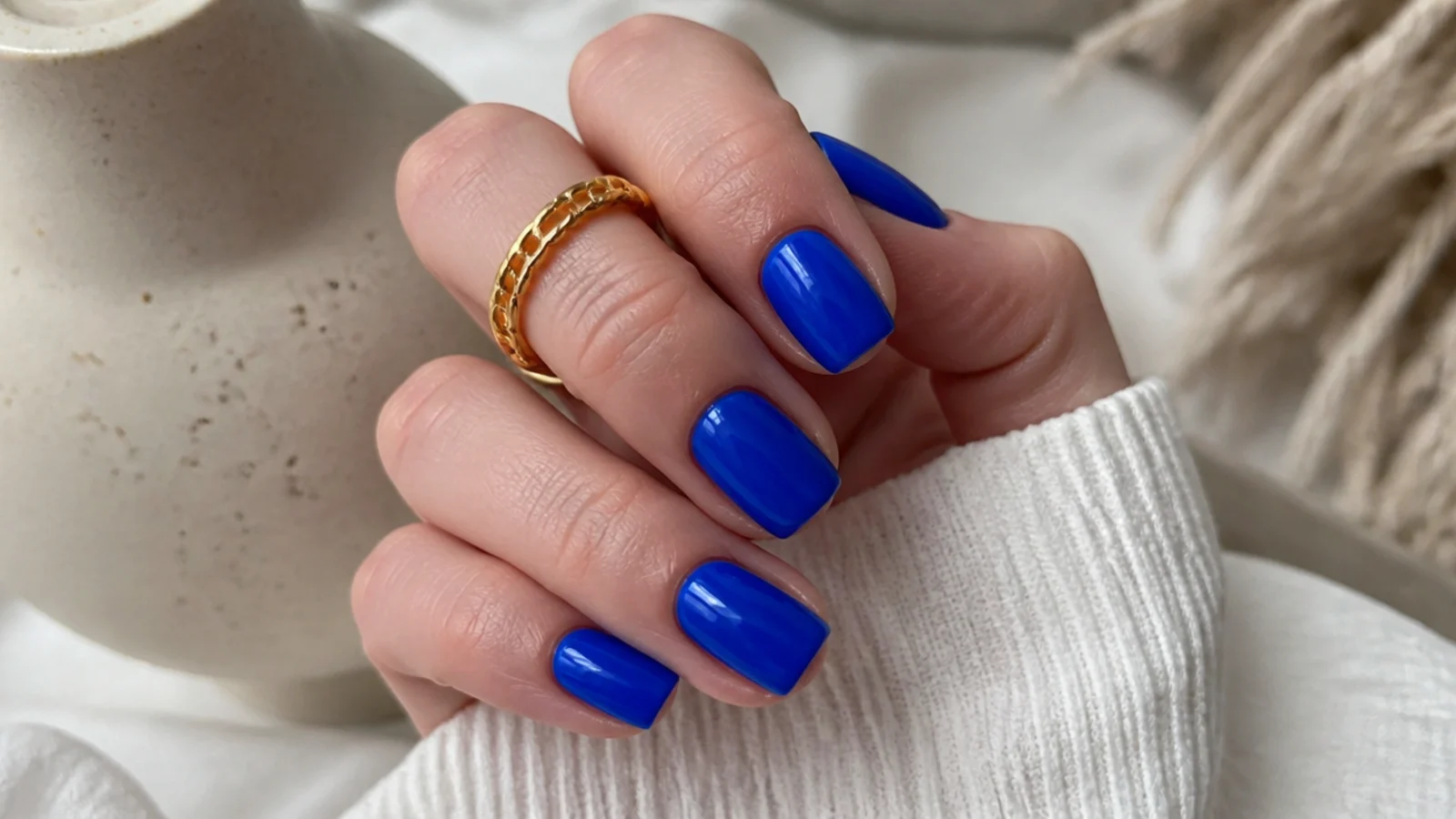 Short royal blue nails in a glossy cobalt on a squoval shape