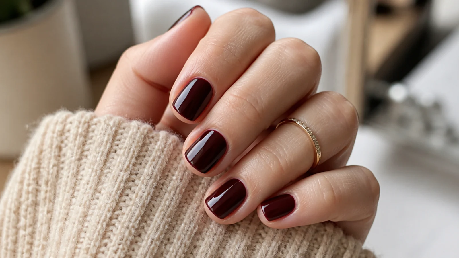 Short soft square nails in near black cherry polish with a deep glossy red undertone