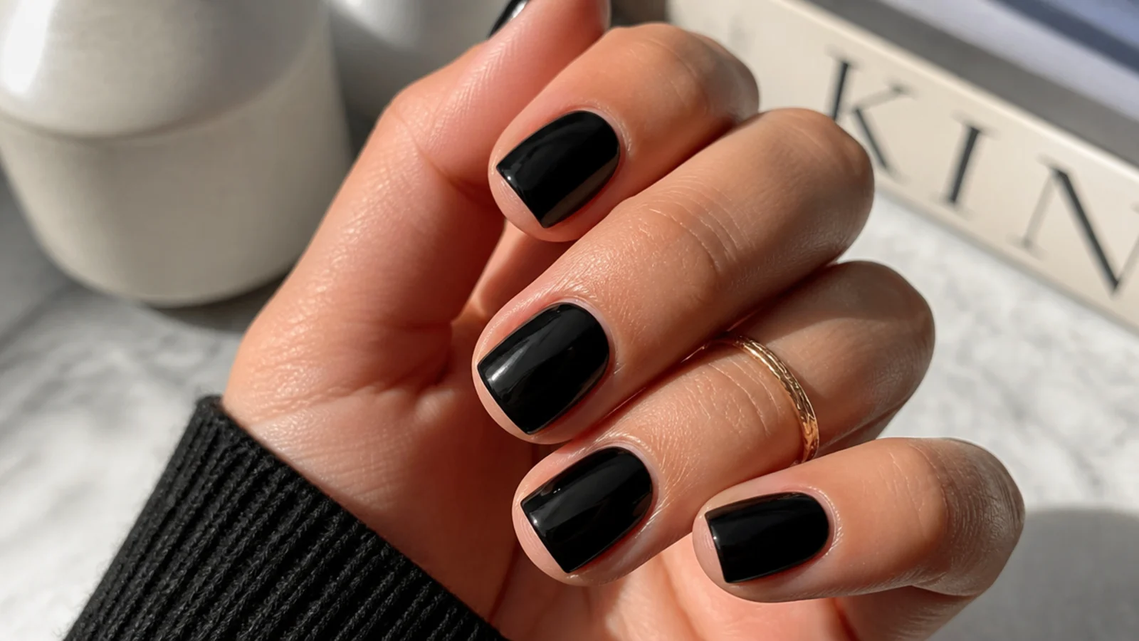 Short square nails in high gloss jet black with sharp even corners and tidy cuticles