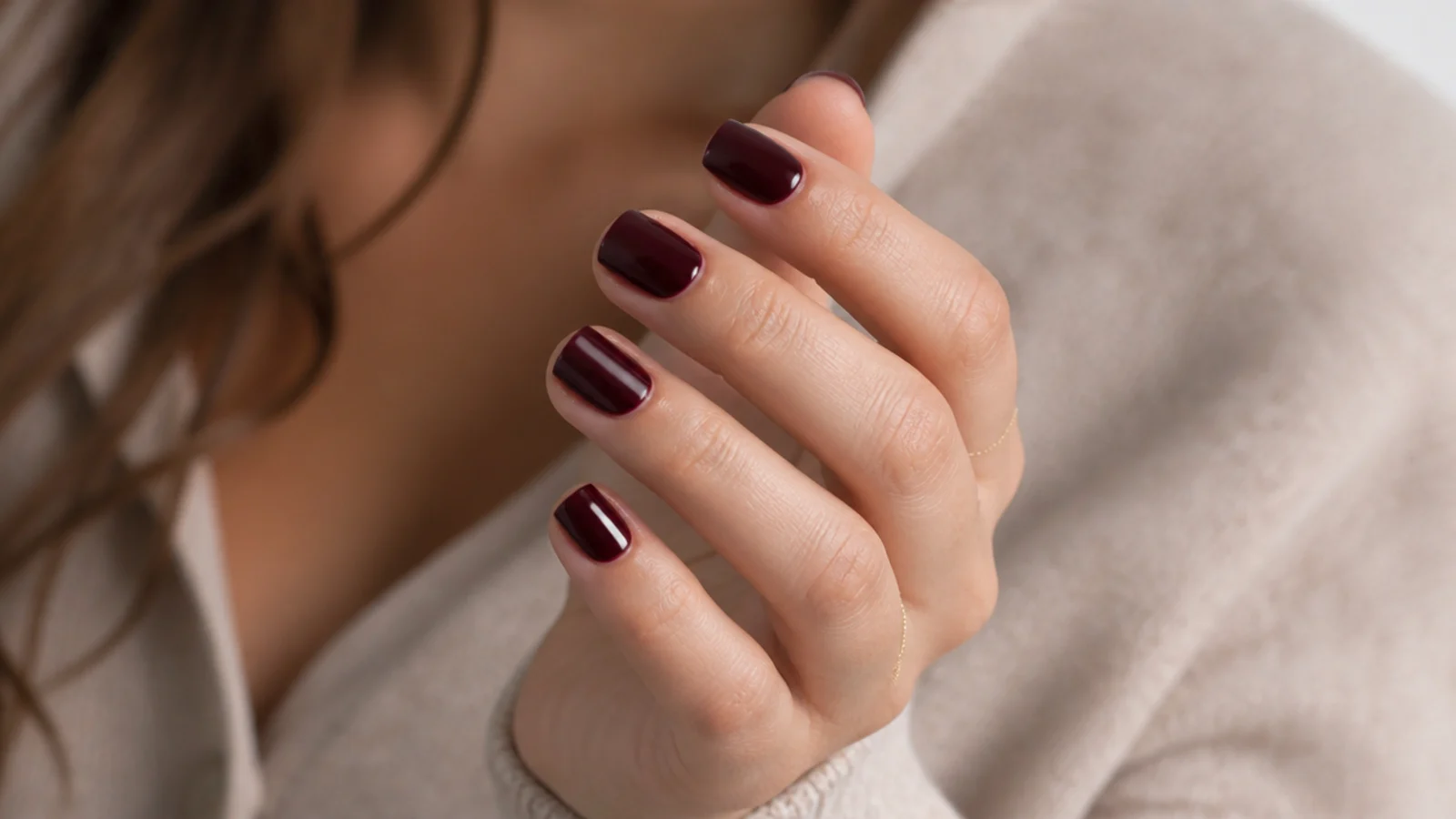 Short squared off nails in near black cherry red with a mirror level gloss finish