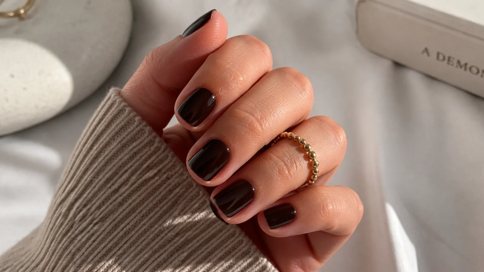 Short square nails in deep espresso brown with a high gloss finish