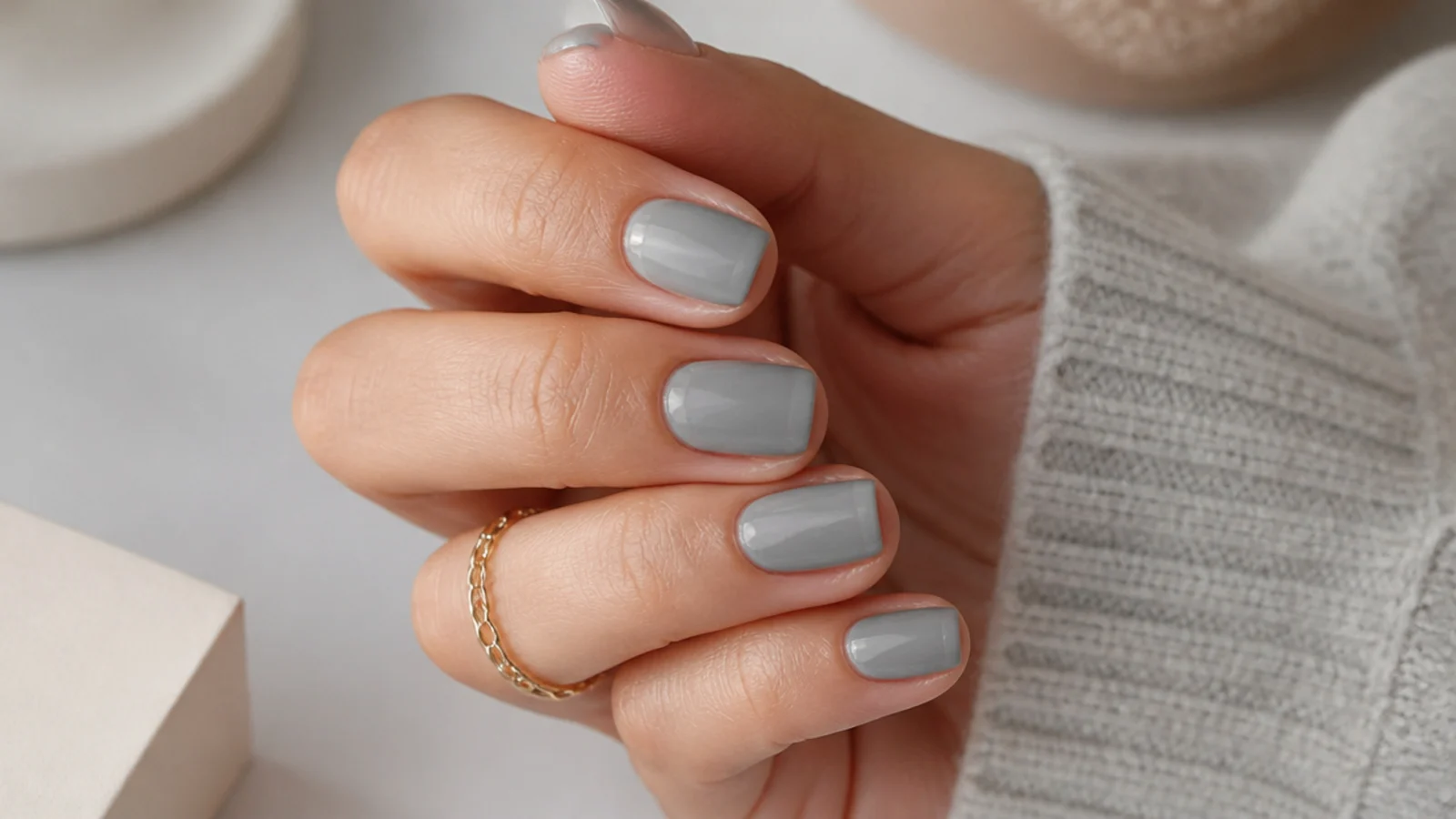 Short nails in matte dove gray with a glossy clear band along the free edge