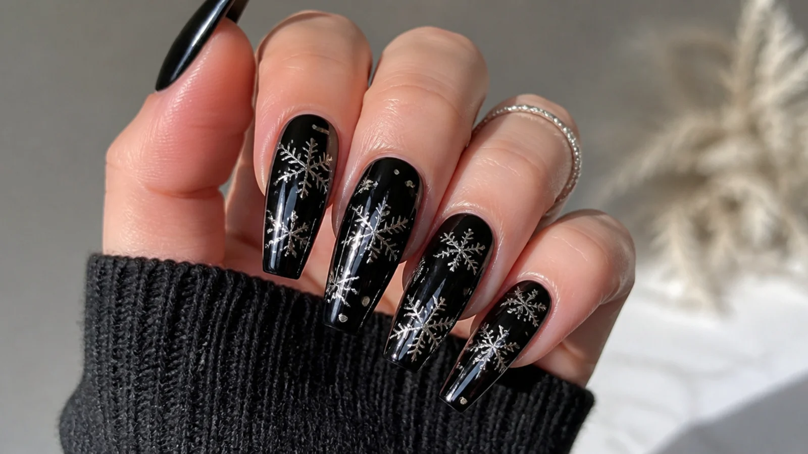 Metallic silver chrome snowflakes on glossy black coffin nails