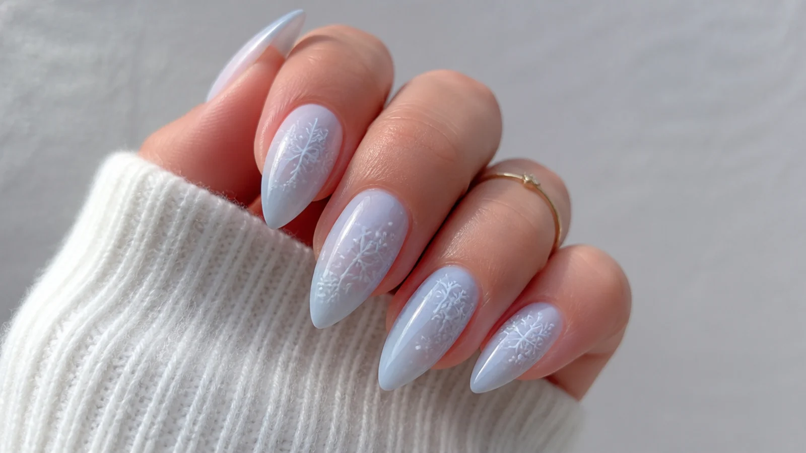 Soft milky powder blue snowflake nails with subtle white flakes