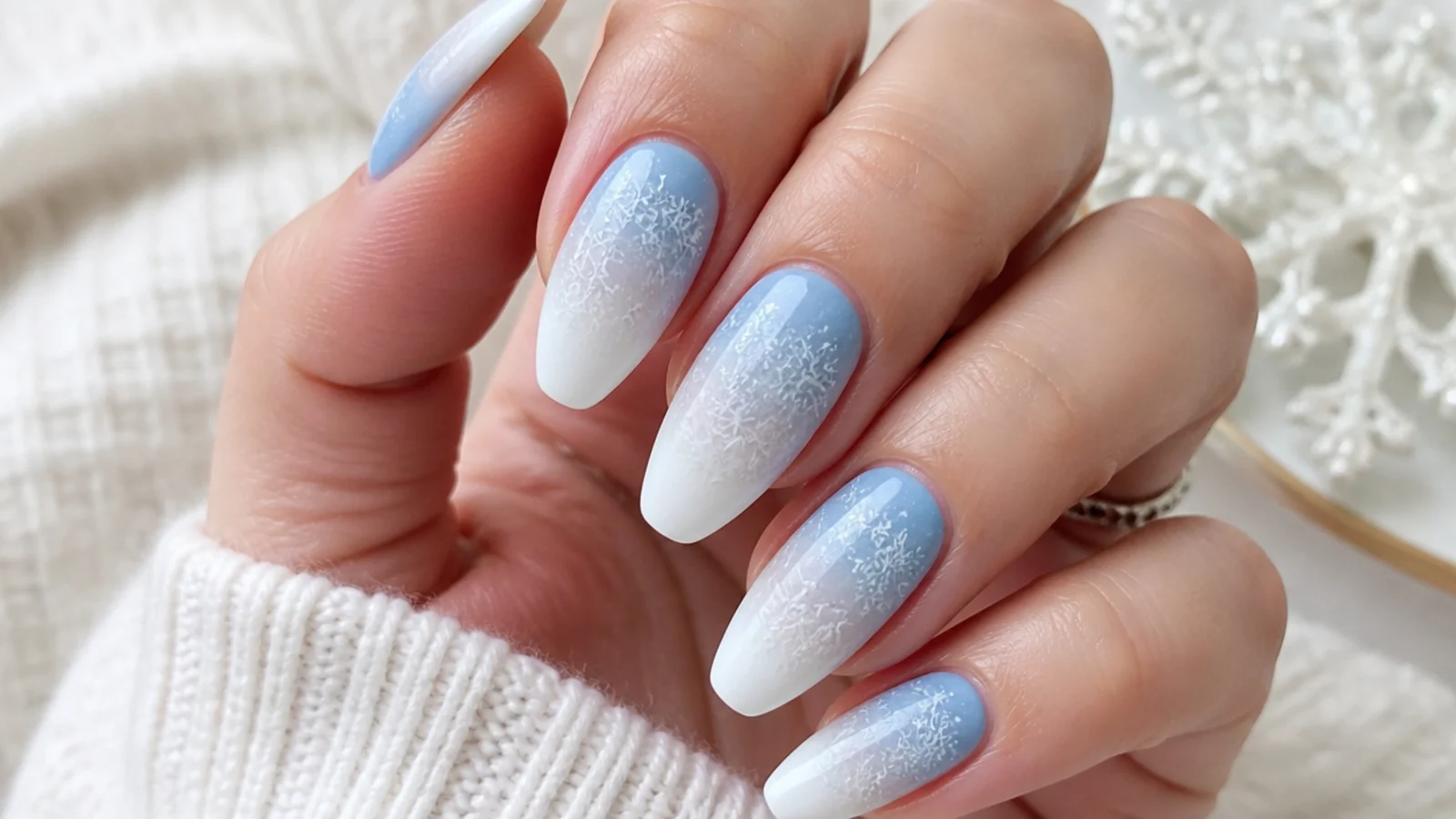 Blue to white ombre snowflake nails fading from icy blue to white tips