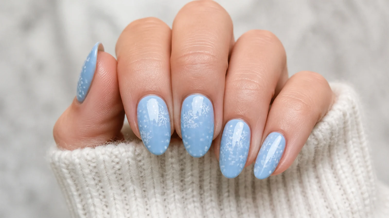 Sky blue nails with tiny white dots and snowflakes like falling snow