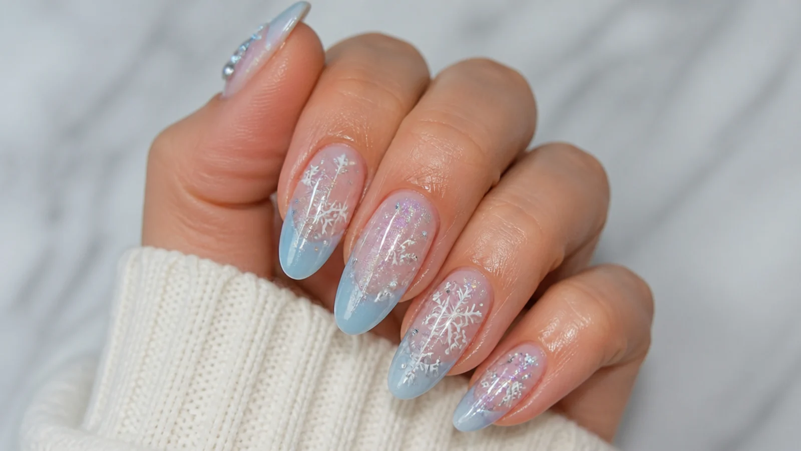 A well-sealed icy blue snowflake manicure with cuticle oil
