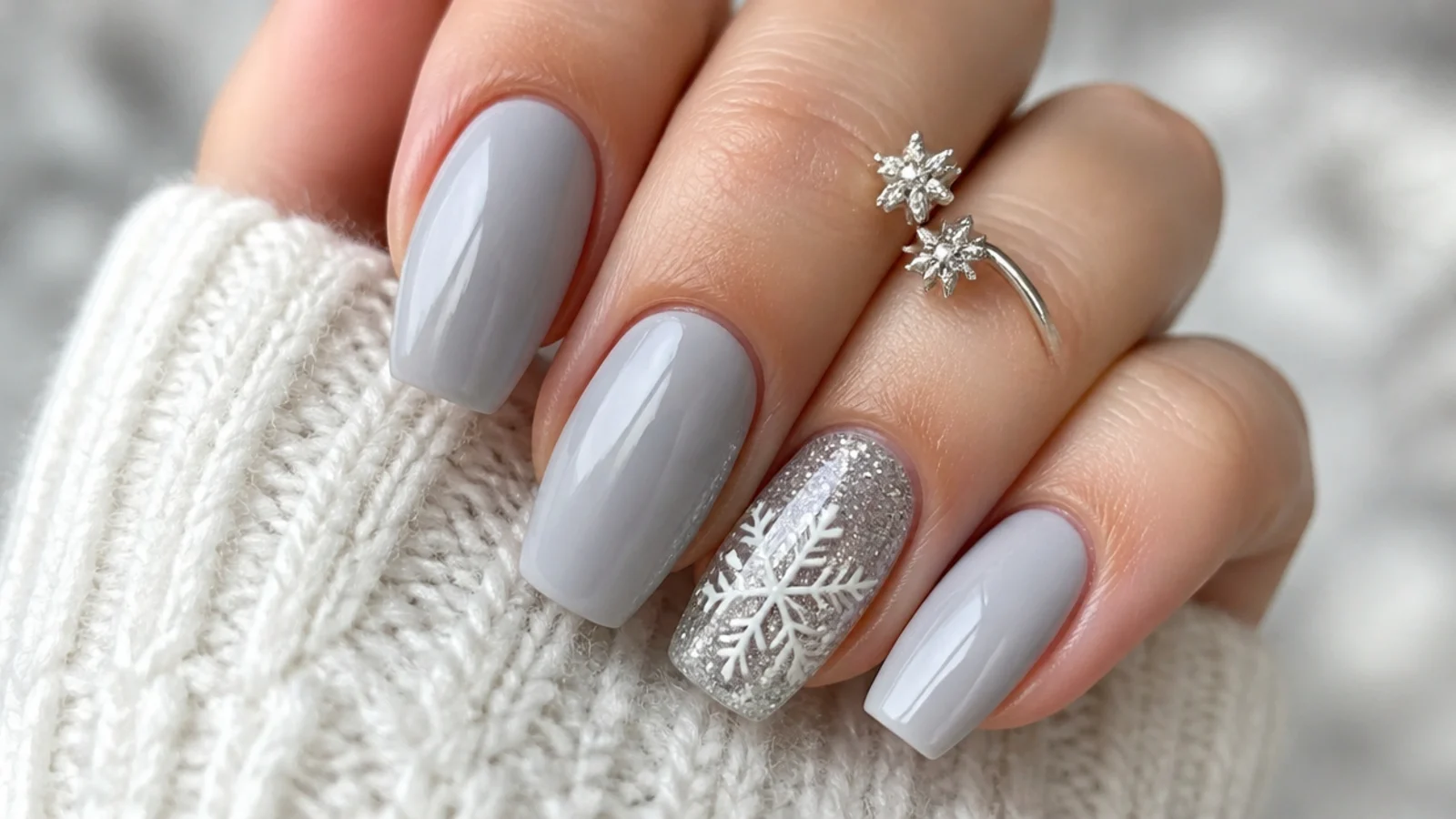 Silver glitter snowflake on a sparkly accent nail among solid nails
