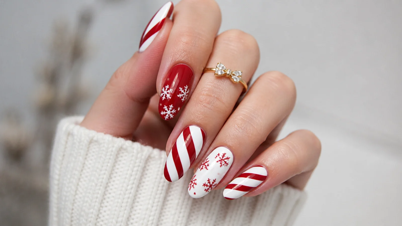 White snowflakes among red and white candy cane stripe accent nails