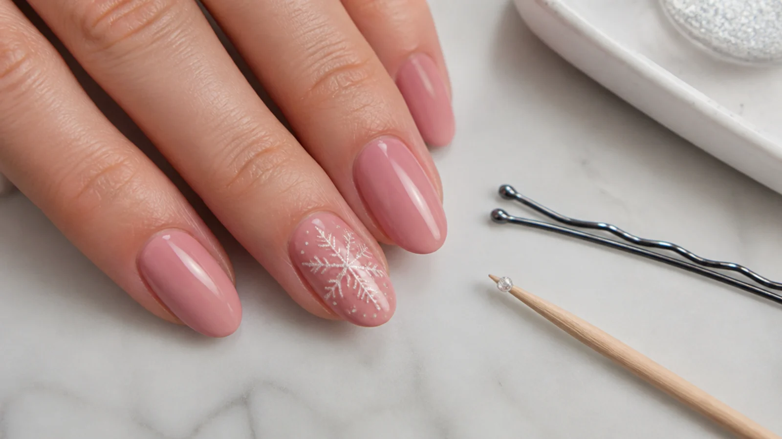 A bobby pin and toothpick used to dot a glitter snowflake on a nail