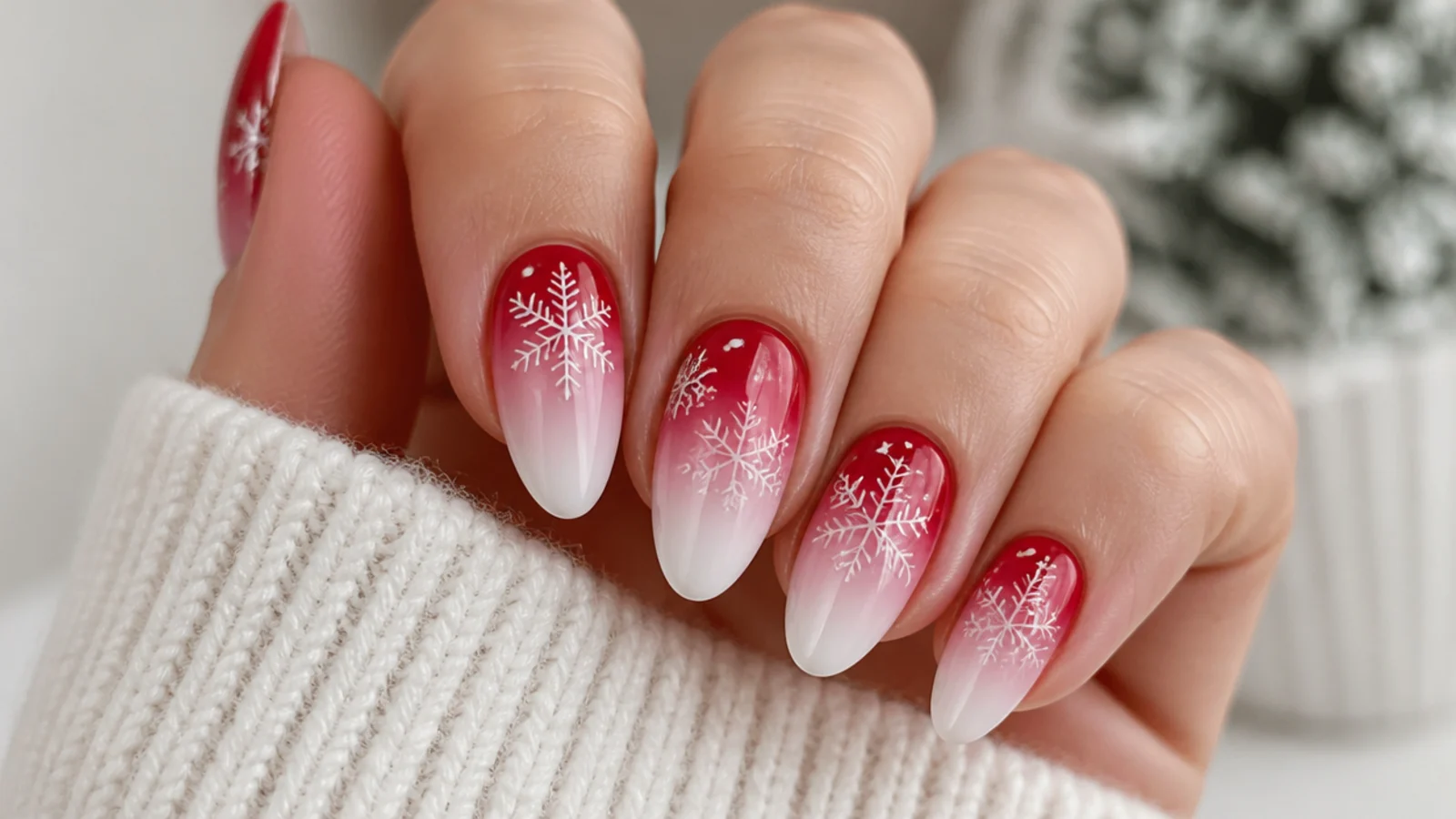Red to white ombre nails with white snowflakes over the fade