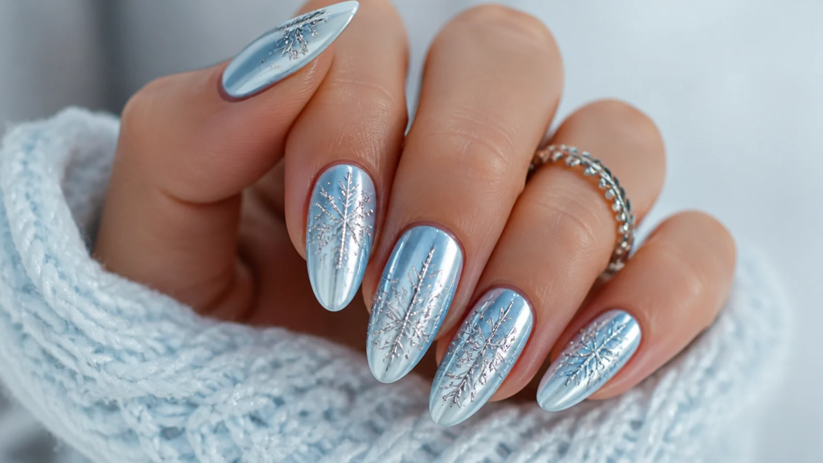 Silver chrome snowflake on an icy blue chrome base, frosted nails