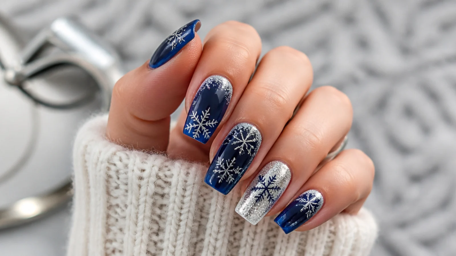 Navy blue acrylic nails with silver snowflakes and frost accents