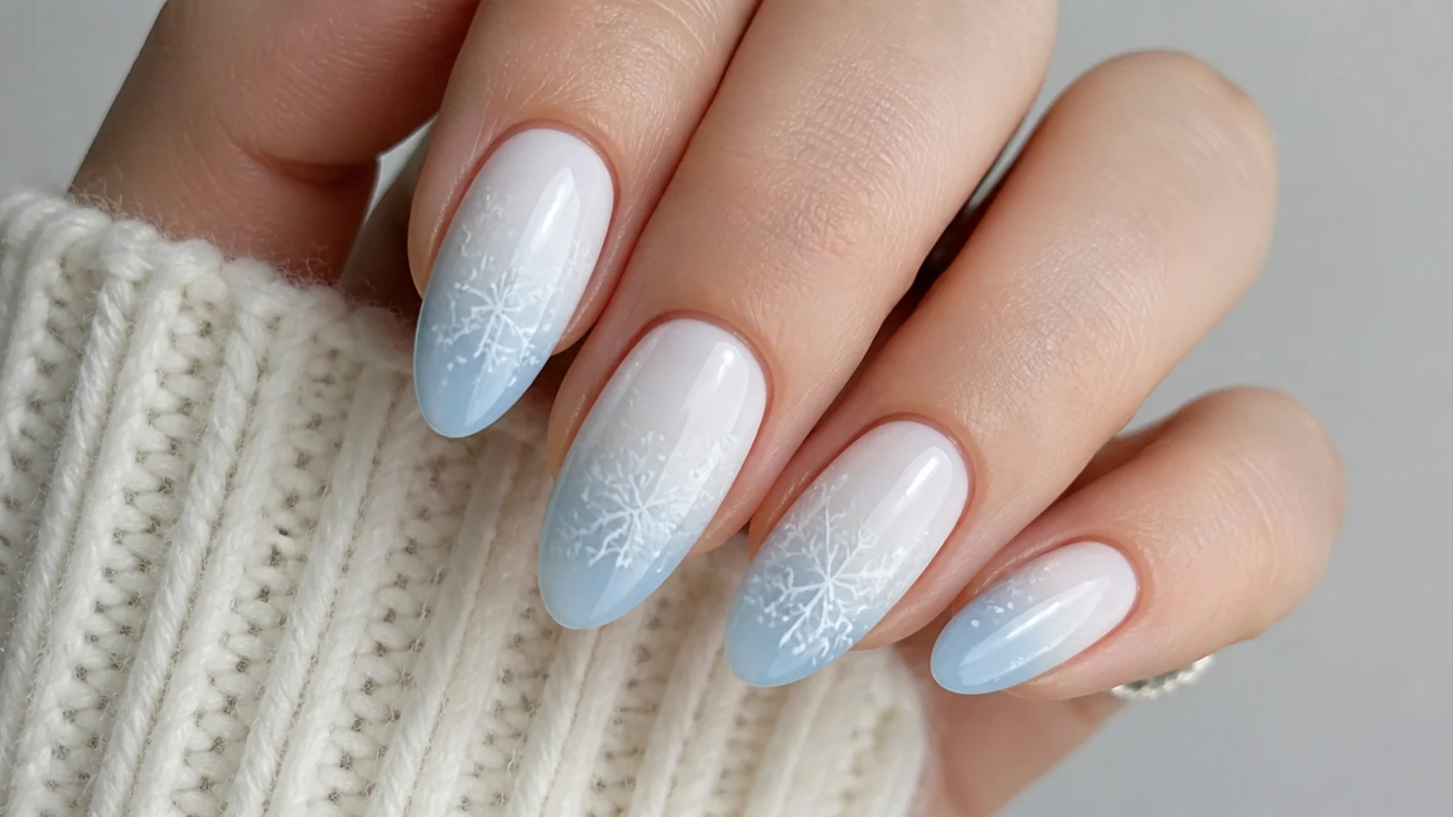 White to powder blue ombre snowflake nails with fine flakes