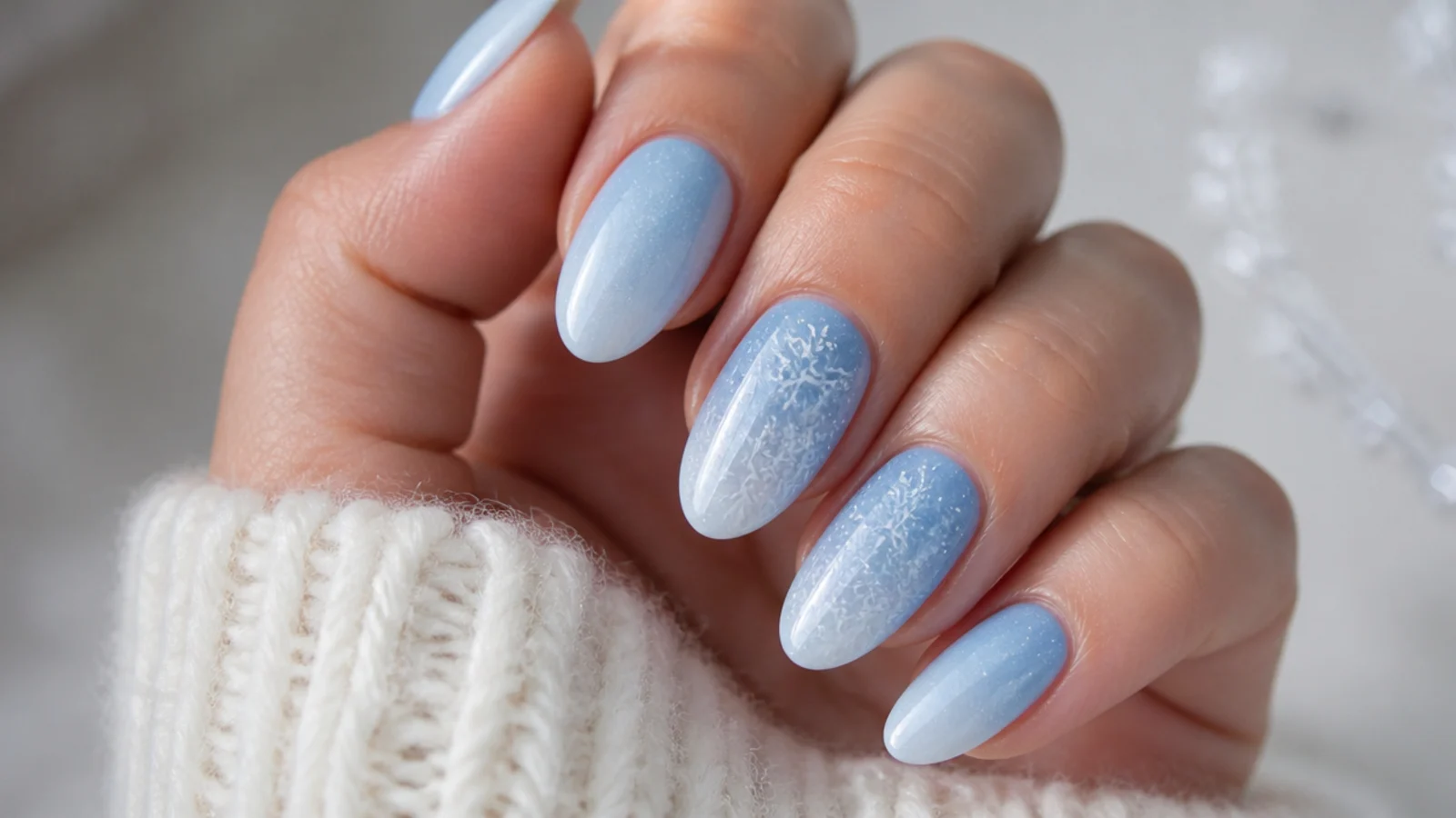 Icy blue nails with a cluster of small white snowflakes