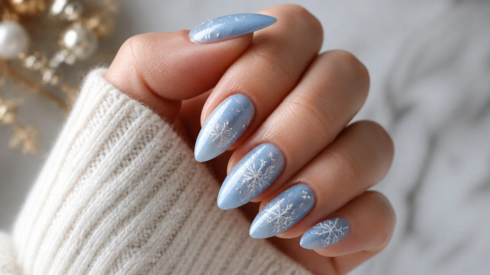 Icy blue snowflake nails with fine white snowflakes and silver detail