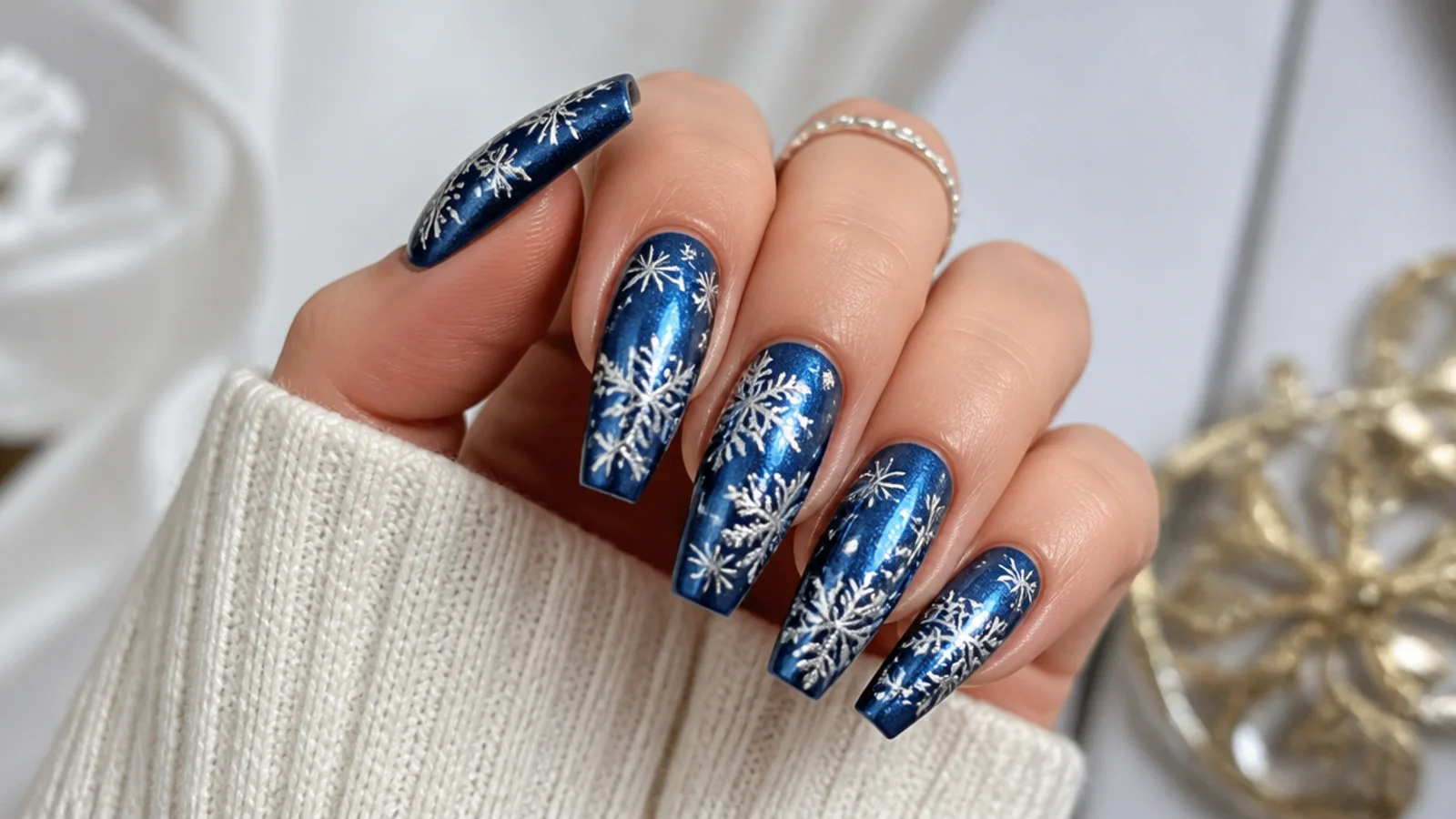 Mirror silver chrome snowflakes over a deep blue base on coffin nails
