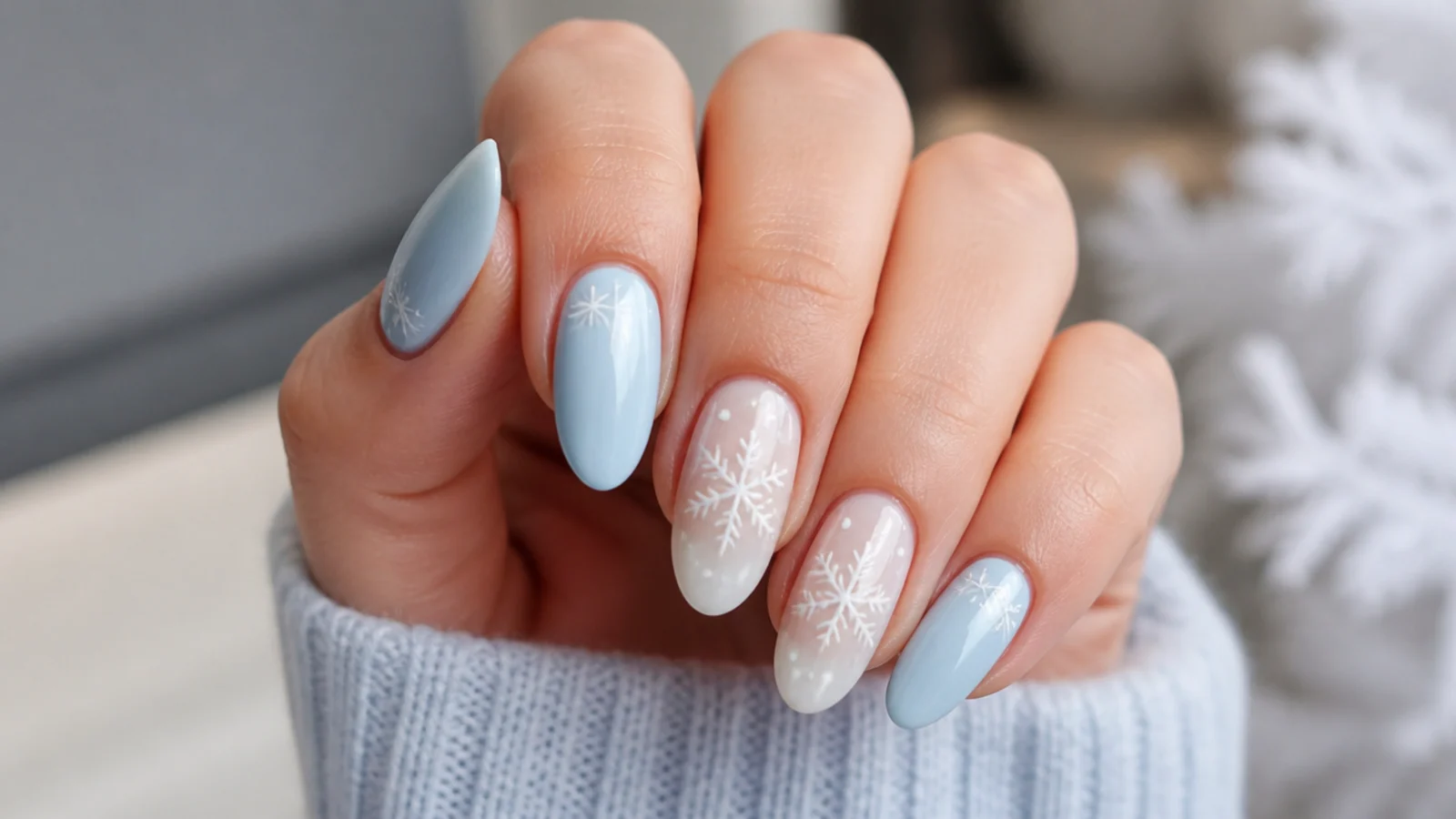 Soft baby blue winter snowflake nails with white snowflakes on a light base