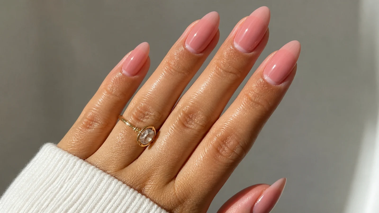 Sheer rosewater pink almond nails with a translucent glassy sheen