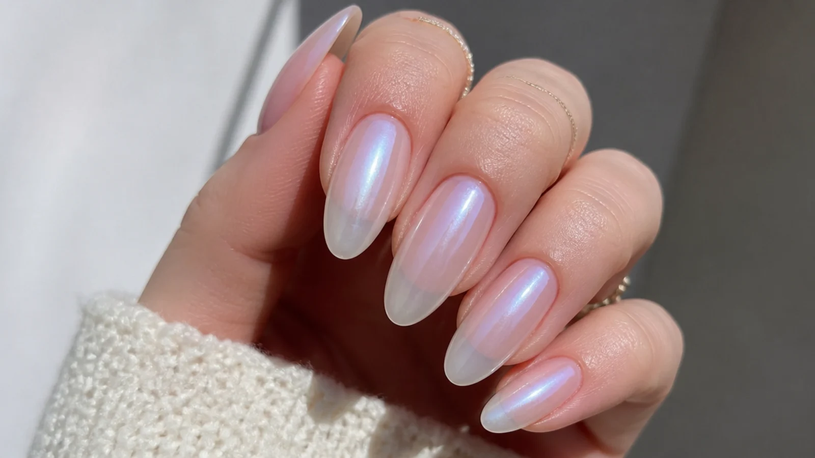 Sheer frosted almond nails with a soft cool pearly translucence