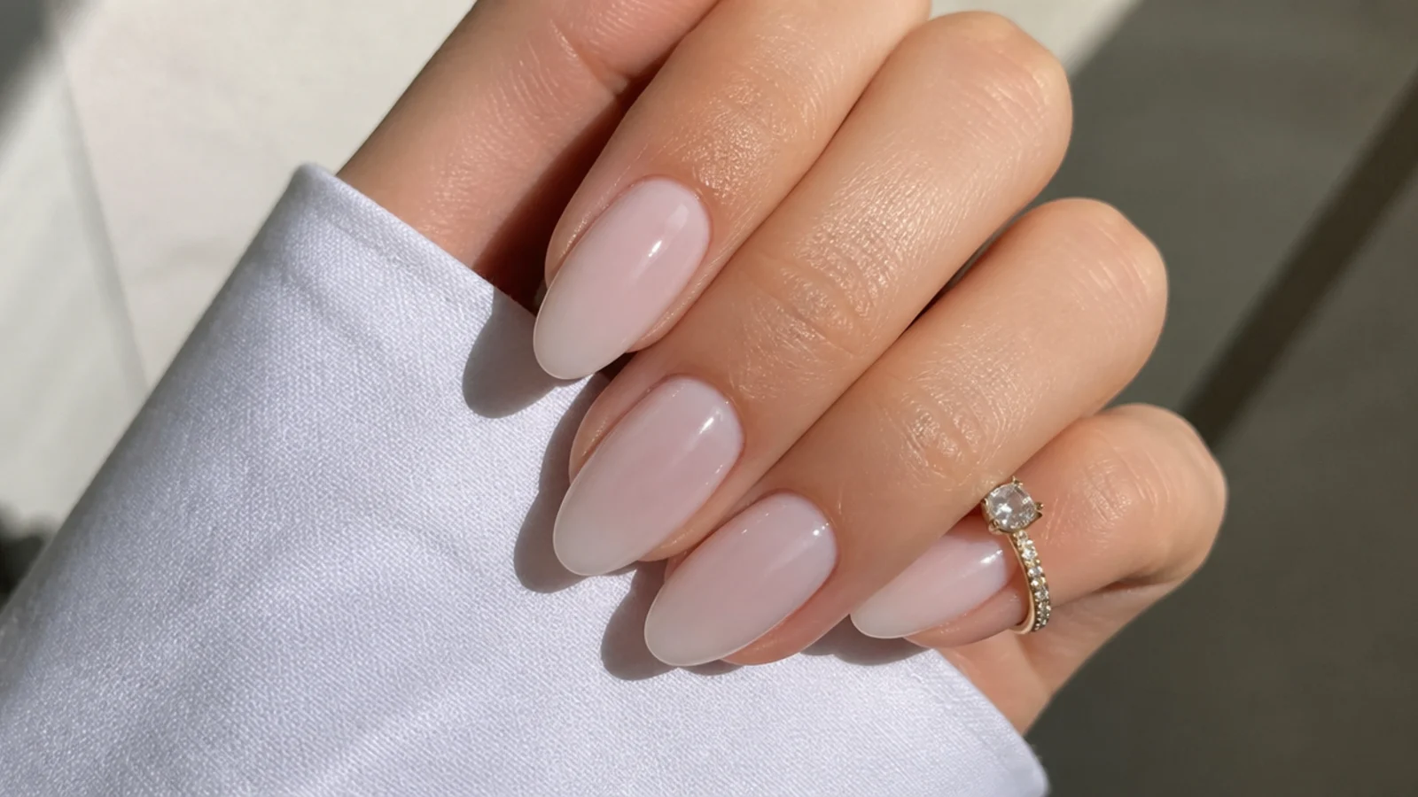Sheer cool-toned pink-white almond soap nails with a clean finish