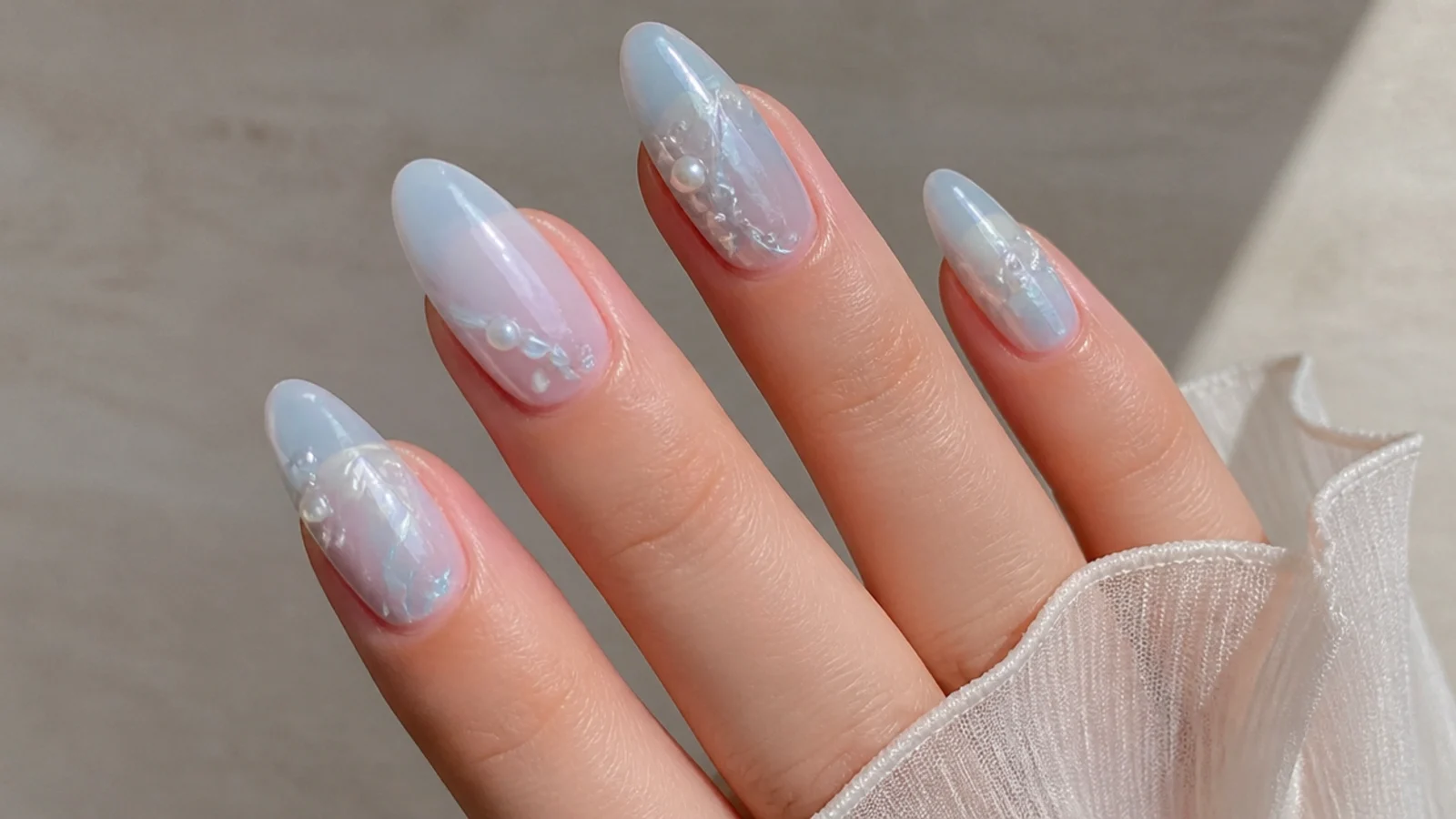 Sheer icy blue-white almond soap nails with a cool translucent finish
