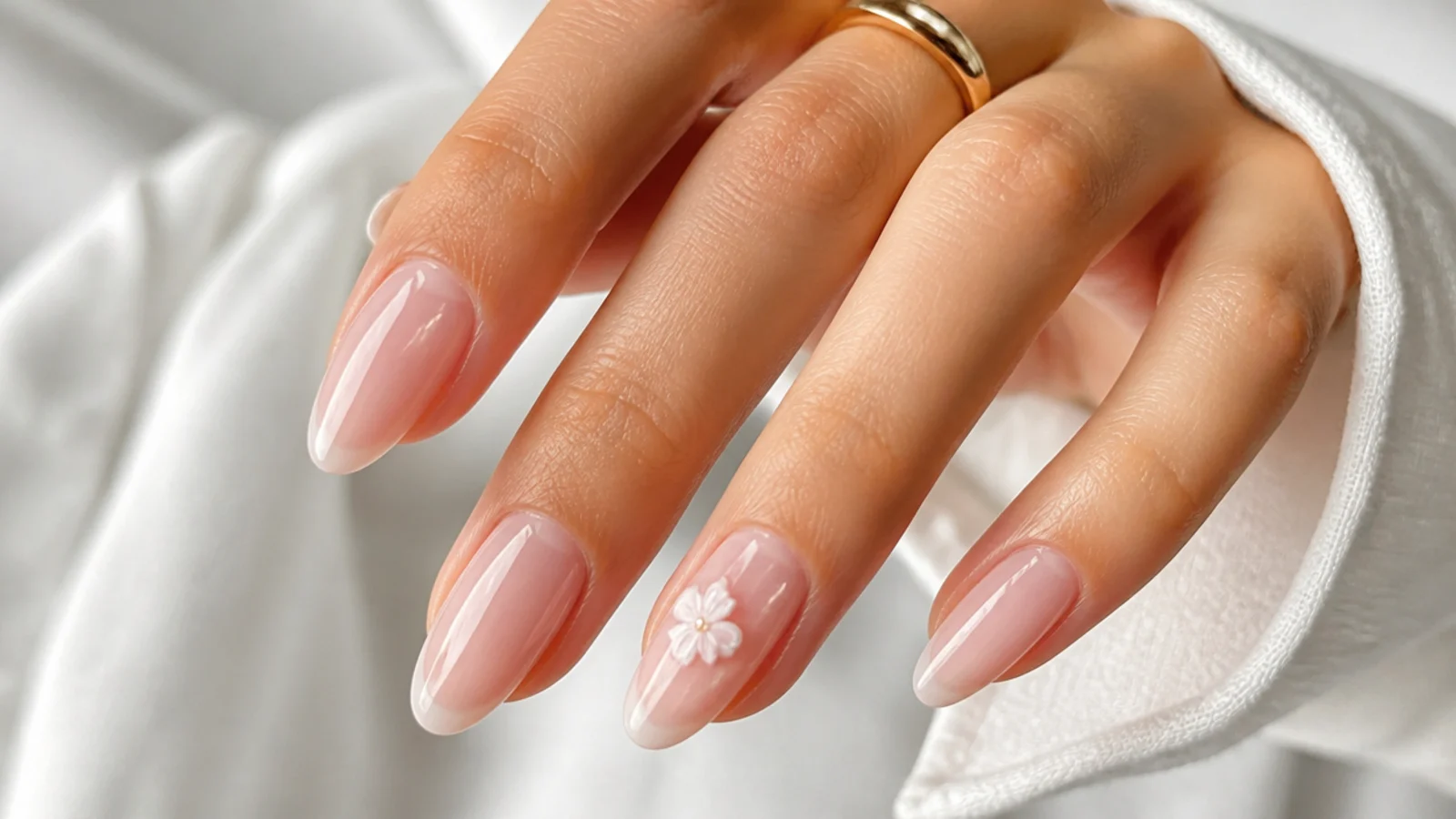 Sheer soft pink soap nails on an almond shape for a bride
