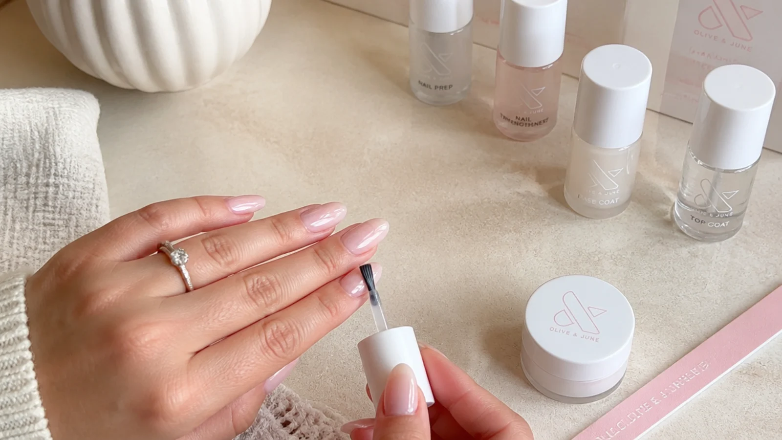 Home soap nails supplies with a nail mid-application in sheer milky-clear