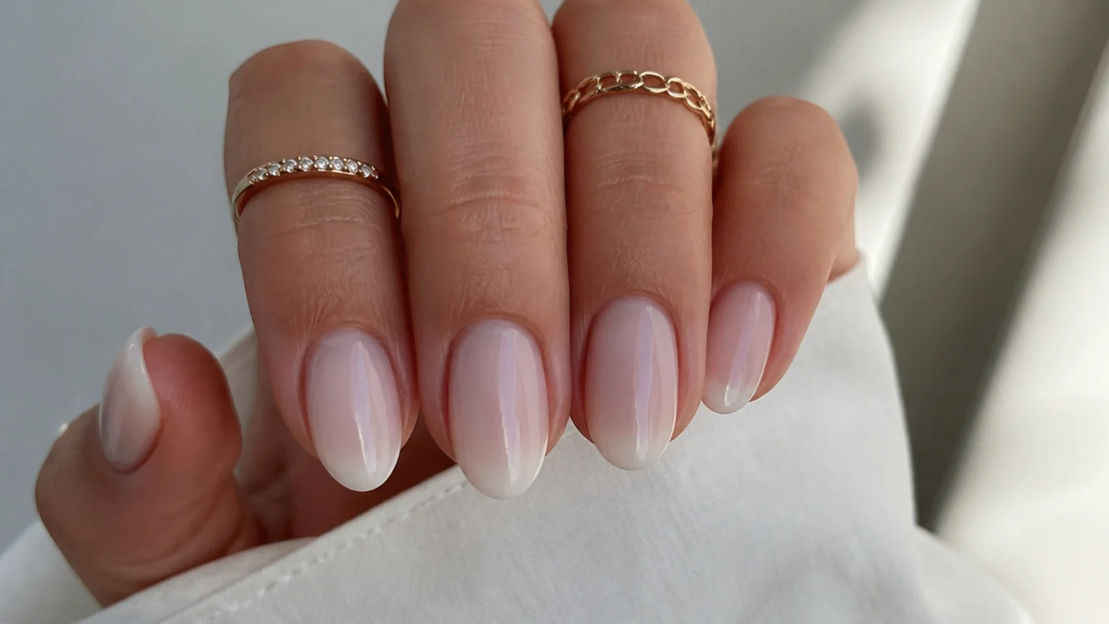 Sheer milky white OPI soap nails on short almond nails with the nail bed showing through