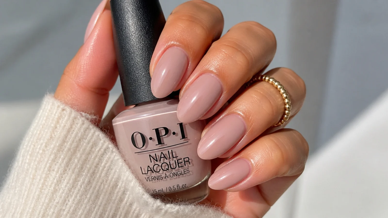 Sheer soft beige-nude OPI soap nails on medium-length almond nails