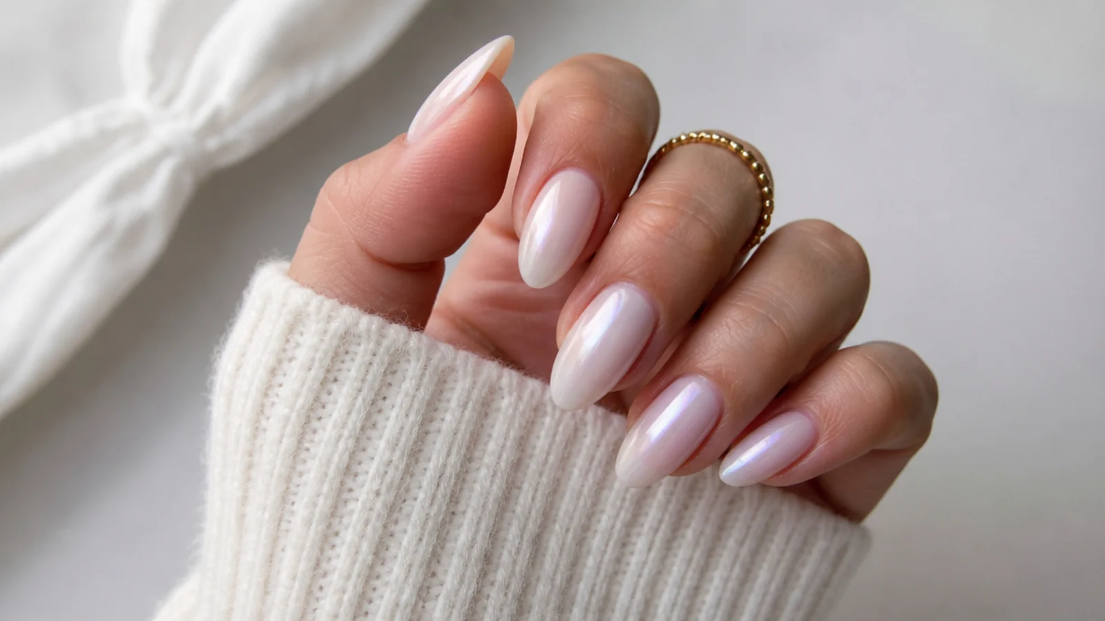 Sheer milky OPI soap nails finished with a soft pearl glaze topper on almond nails