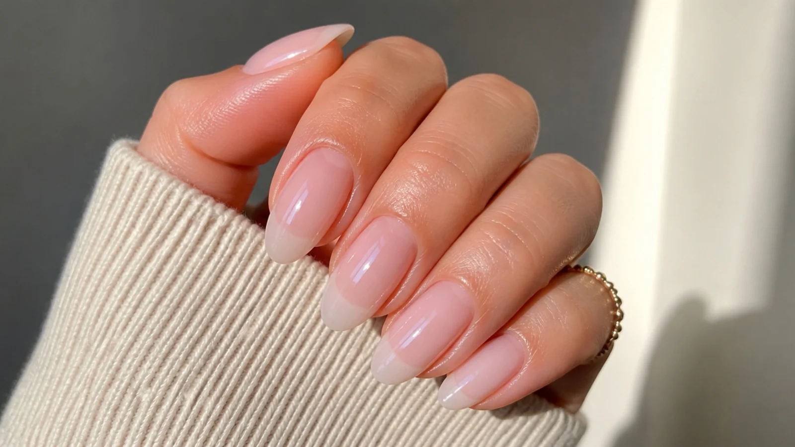 Sheer milky OPI soap nails on an almond shape with the natural nail showing through