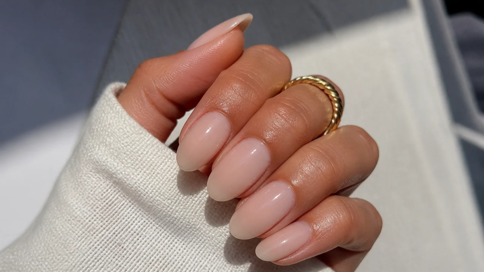 Sheer warm nude oval soap nails matched to a medium skin tone