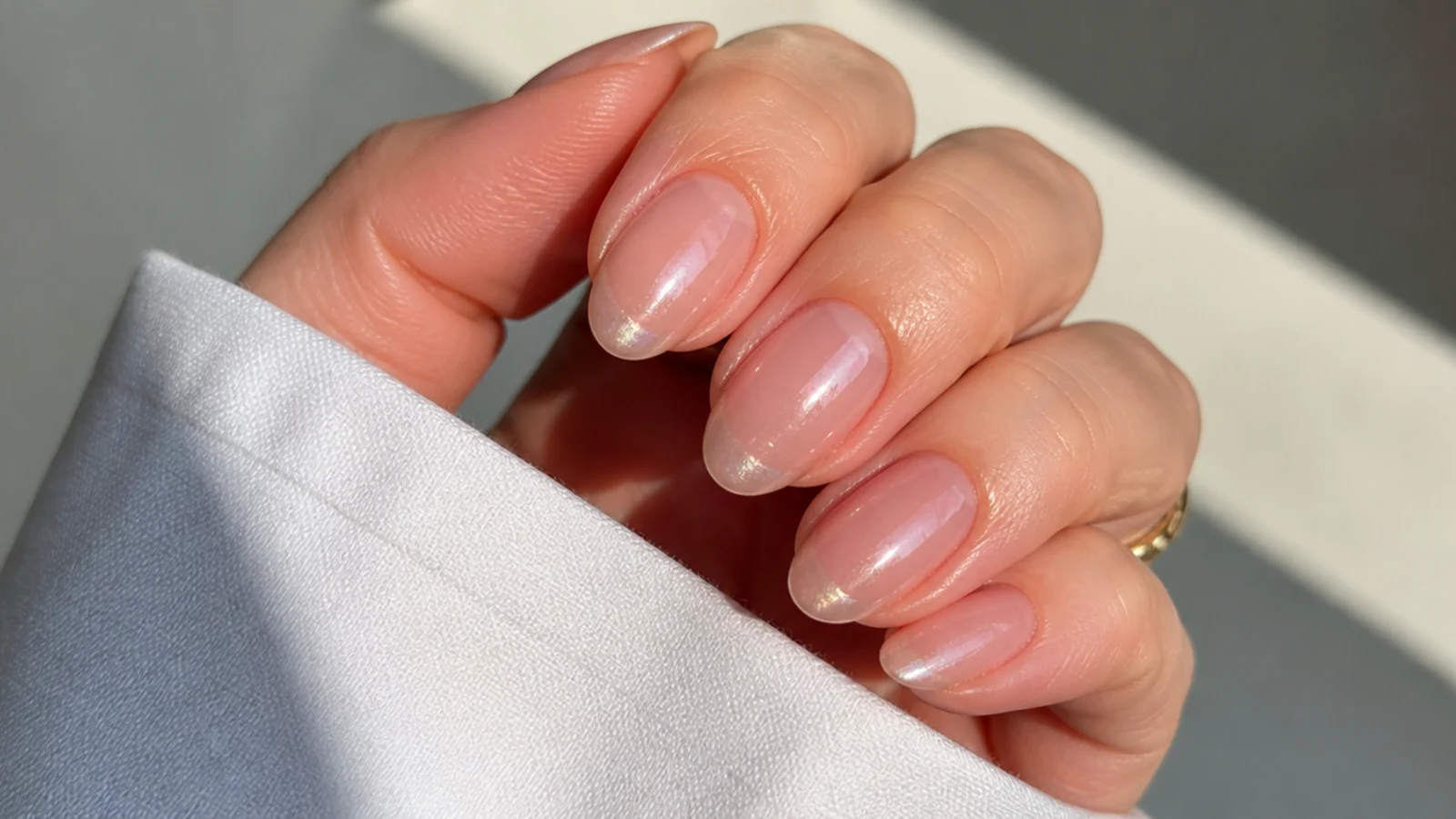 Sheer oval soap nails with a faint glazed chrome sheen at the tips
