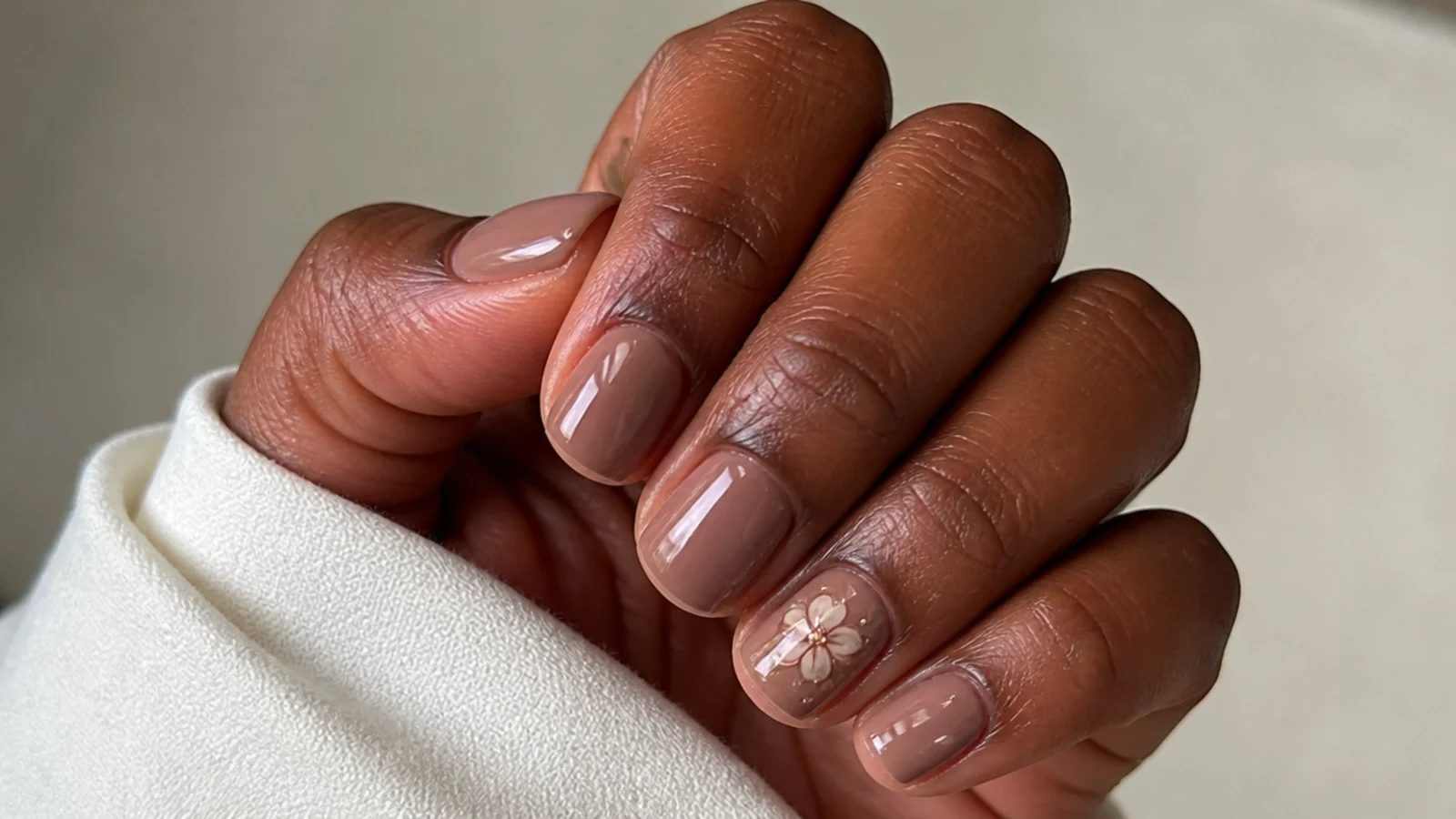 Short soap nails in a sheer warm mocha nude on deep skin