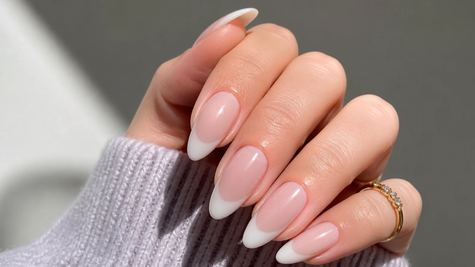 Almond nails with a sheer milky base and a soft translucent white tip