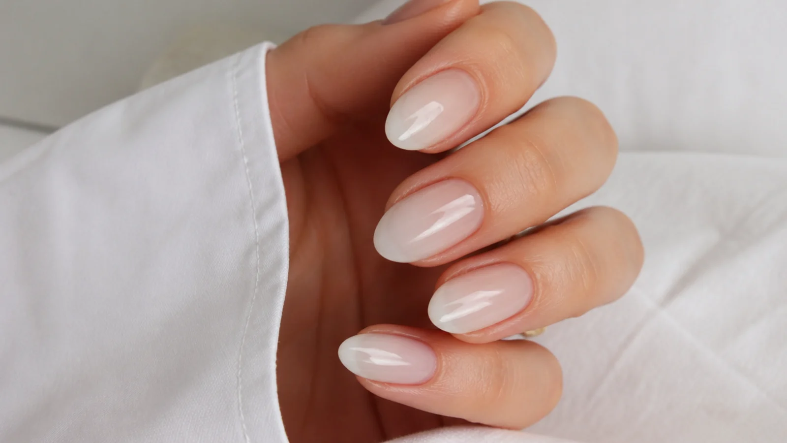 A sheer milky-clear soap manicure on almond nails with the natural nail showing through