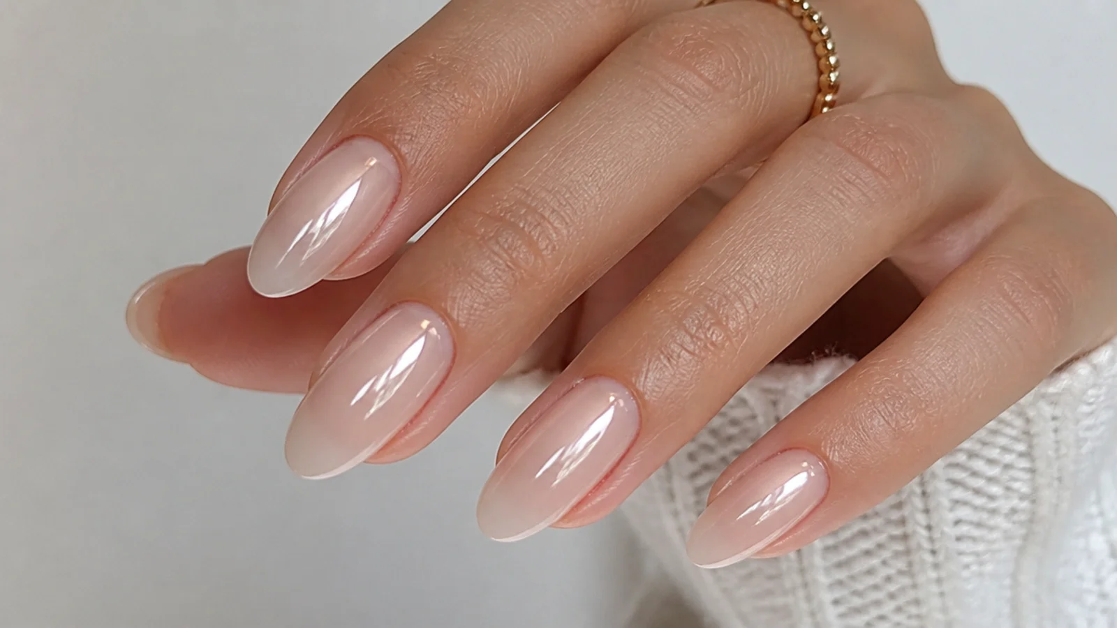 Sheer glassy soap nails in a milky-clear wash on almond-shaped natural nails