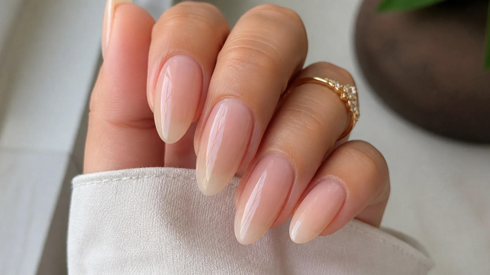 Extremely glossy wet-look sheer soap nails reflecting light on almond shape