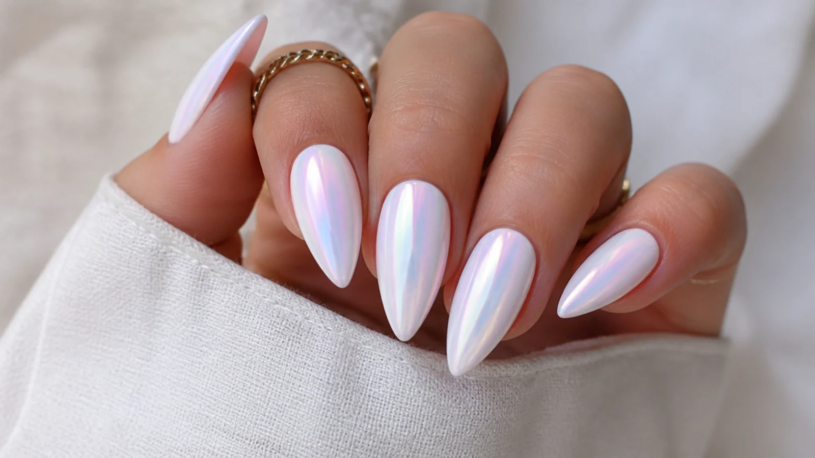 White chrome nails with a color-shifting aurora opal glow in pink and blue