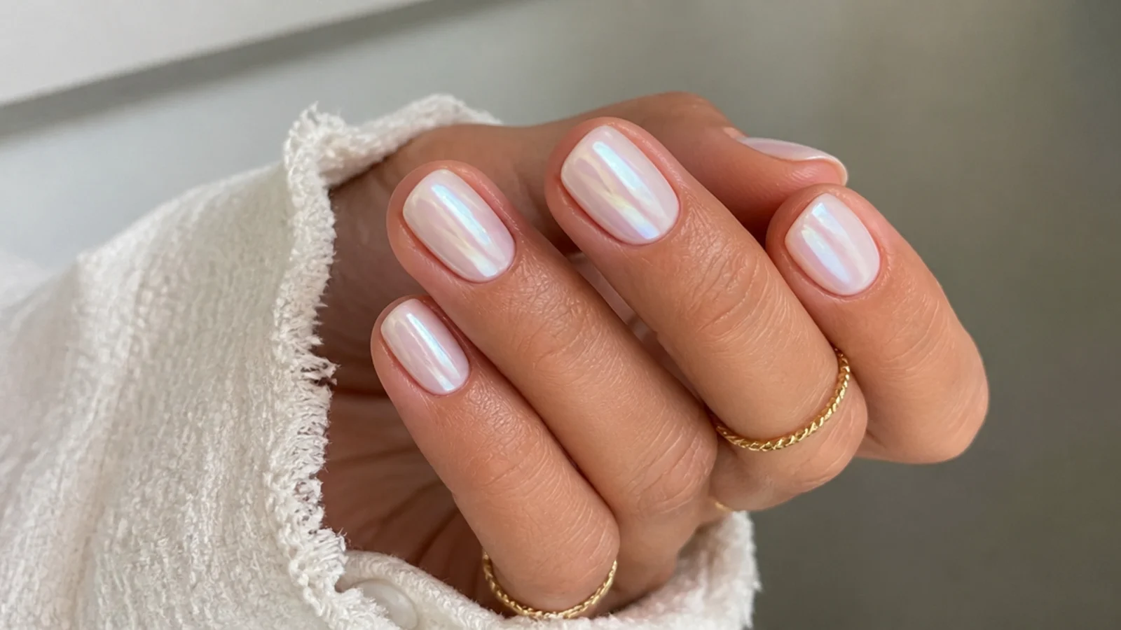 Short squoval white chrome nails with a milky pearl sheen