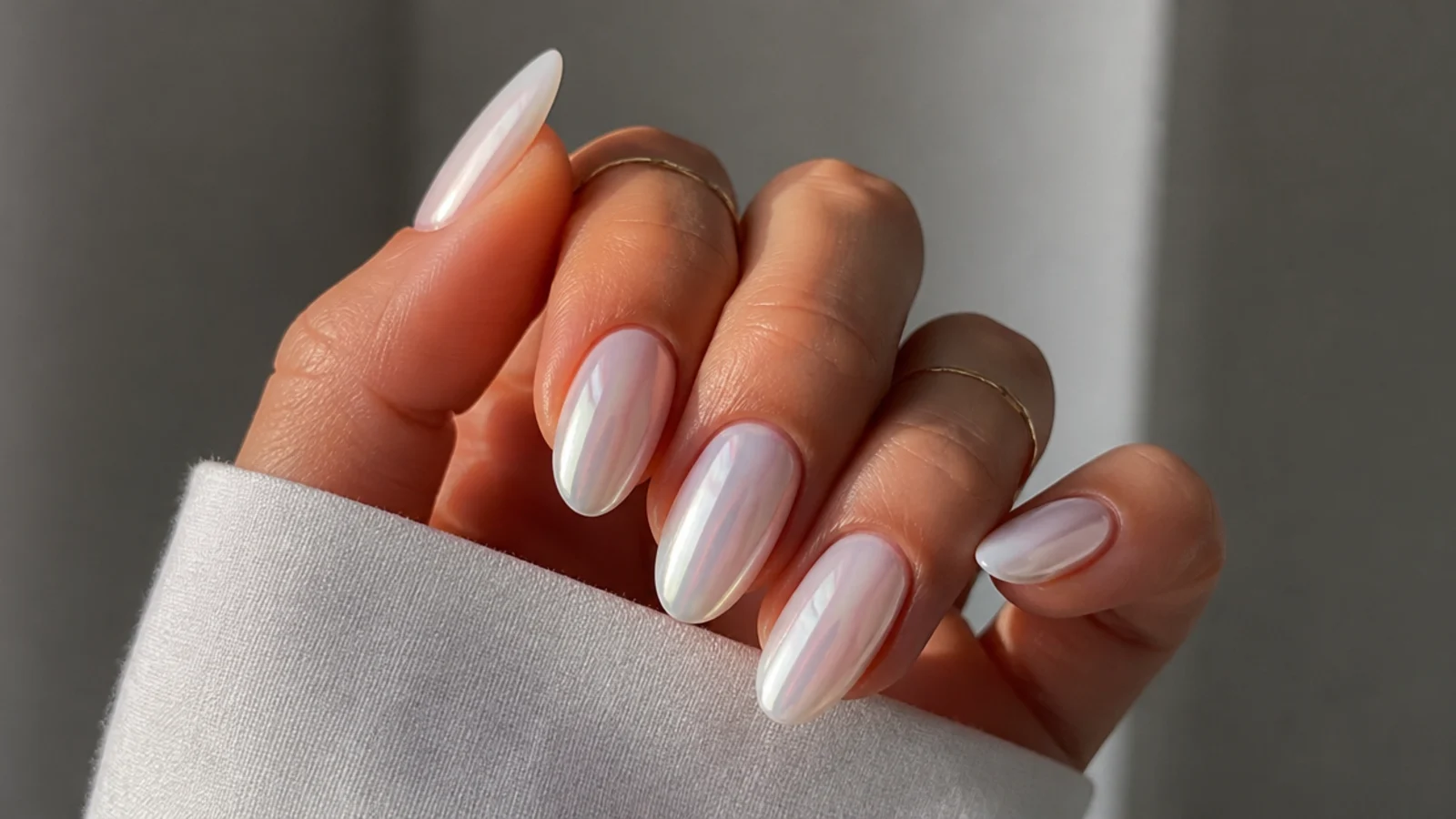 Almond white chrome nails with a soft glazed pearl finish