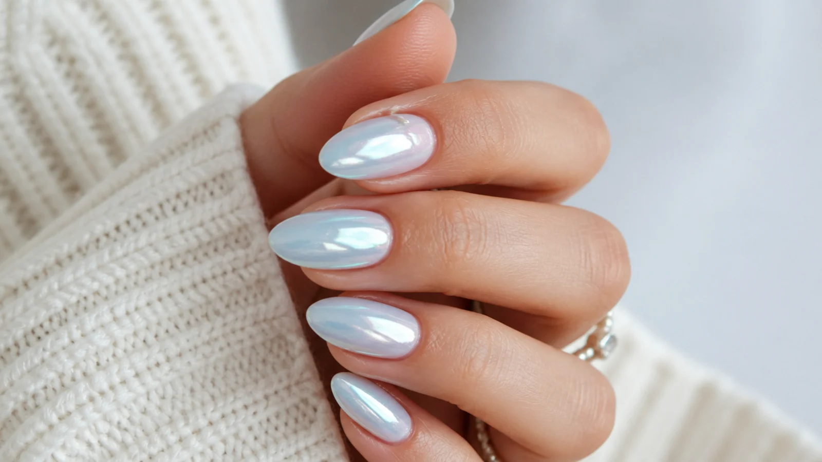 Icy blue-white chrome nails with a cool frosted pearl sheen