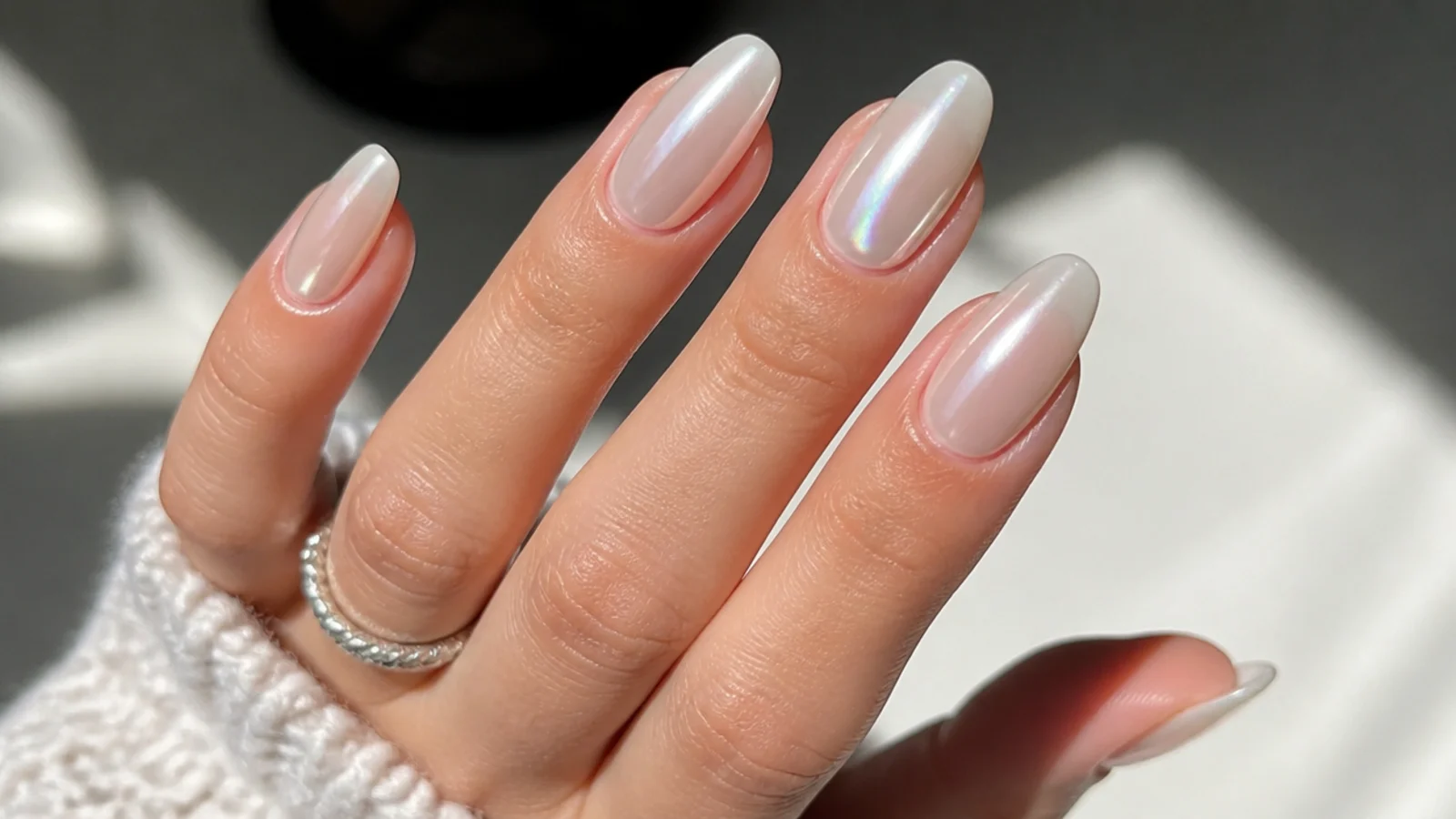 White chrome nails mixing sheer glaze and opaque pearl across the hand