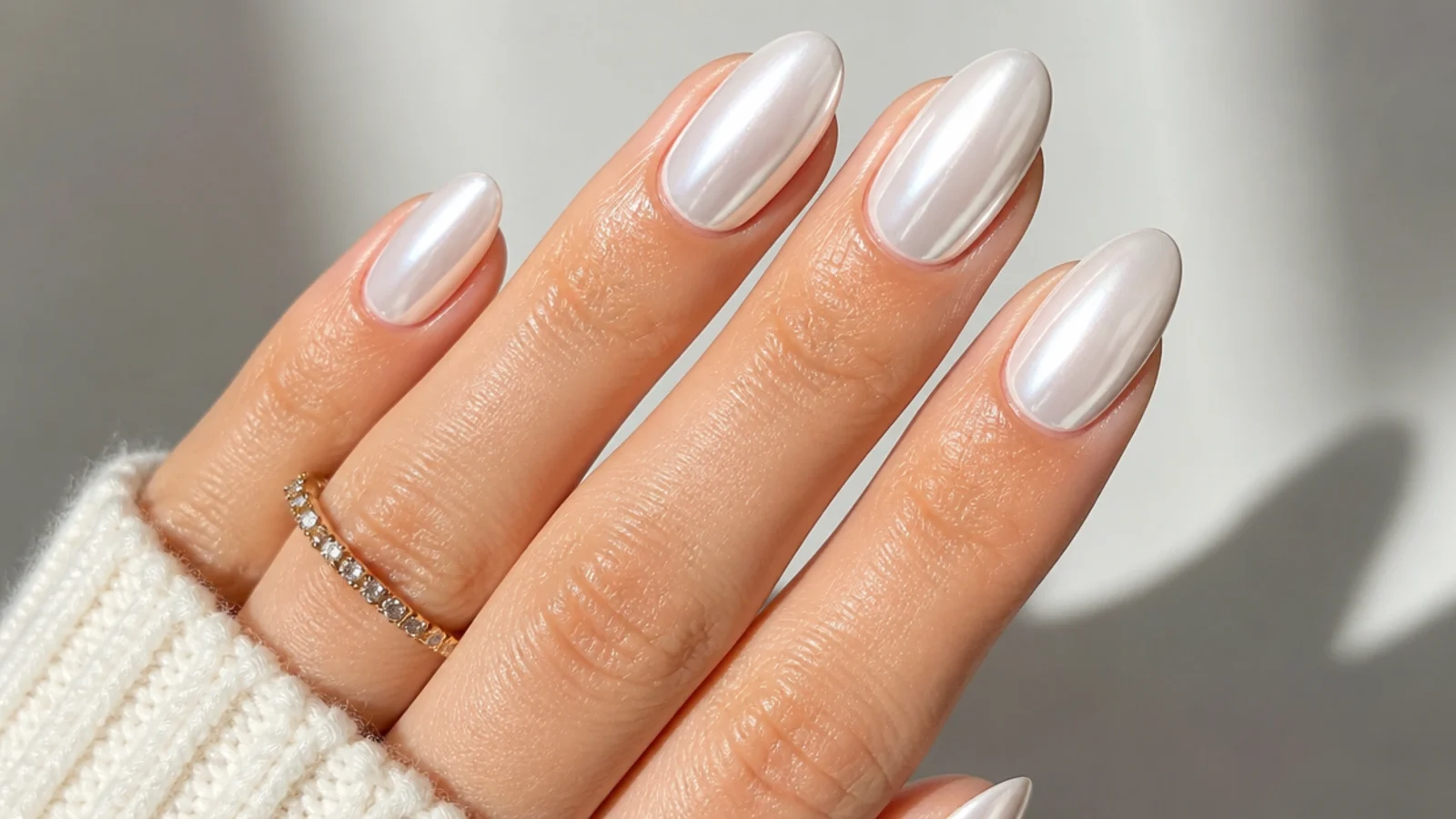 High-shine mirror-pearl white chrome nails buffed to a glassy finish