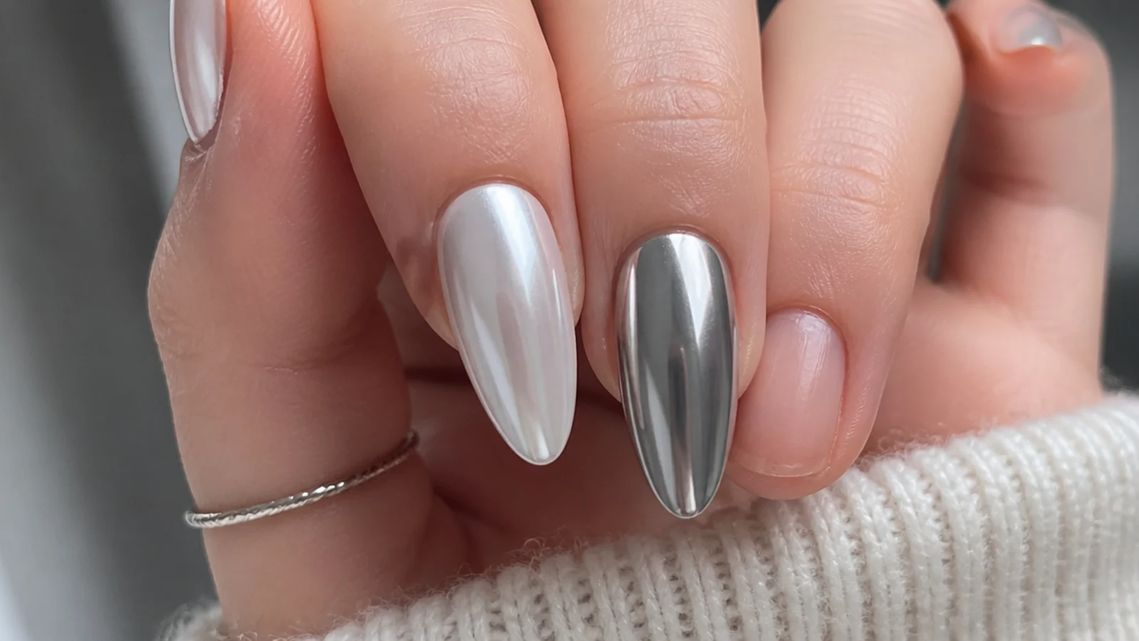 Soft pearl white chrome nail beside a hard mirror silver chrome nail