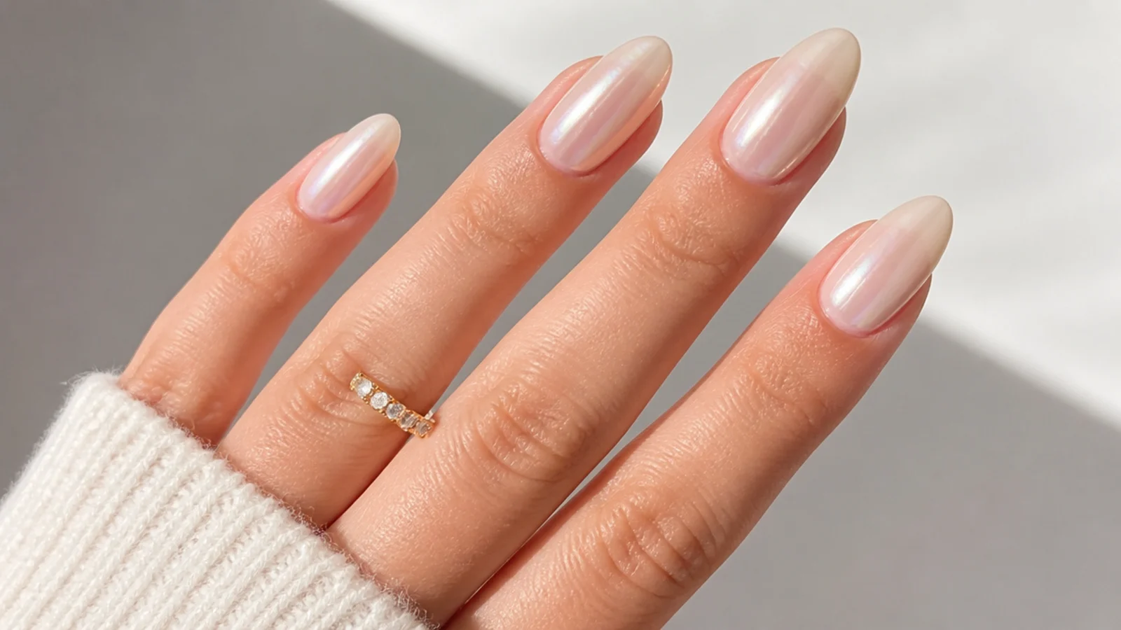 Soft bridal milky pearl white chrome nails on a long almond shape